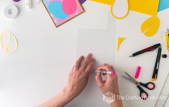 tracing the egg shape onto the acetate