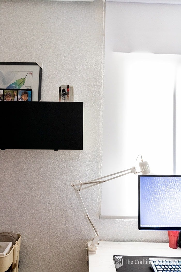 A view of part of the desk with monitor and lamp and part of the trofast ikea drawer