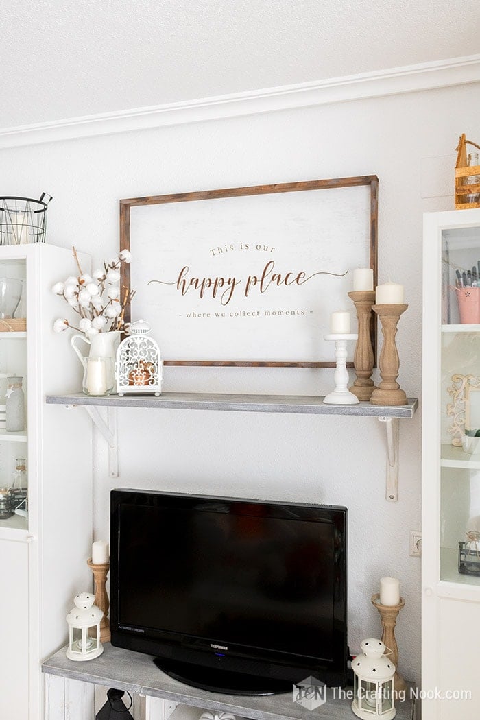 Rustic wood sign on the wall with Our Happy place sentiment.