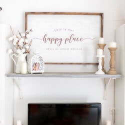 Rustic wood sign on the wall with Our Happy place sentiment.