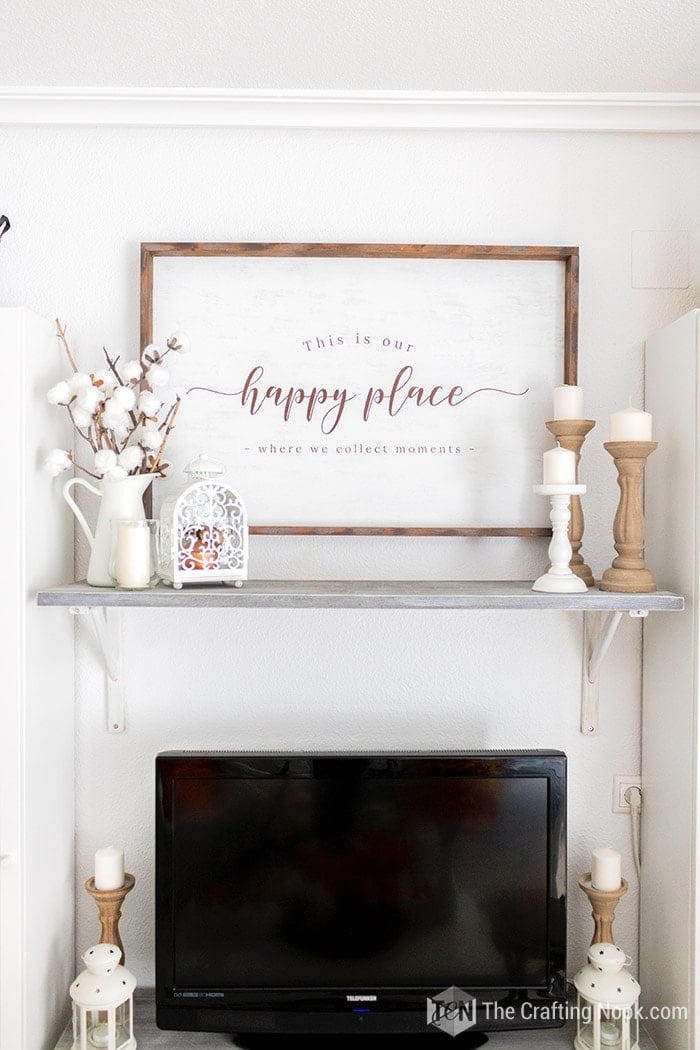 Rustic wood sign on the wall with Our Happy place sentiment.