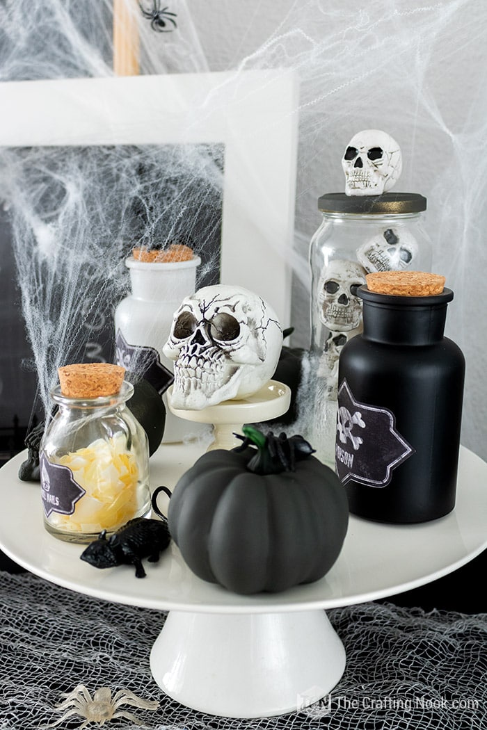 Potion Bottles, skulls and pumpkins on a cake stand. Fall Halloween decor