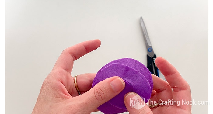 placing a felt circle at the base of the plastic eye