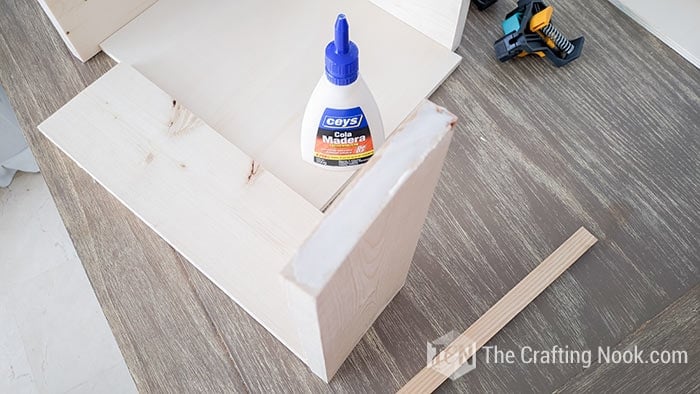 applying glue to the end of the side boards 