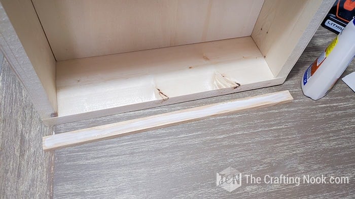 image of extra piece with glue to attach to the drawer