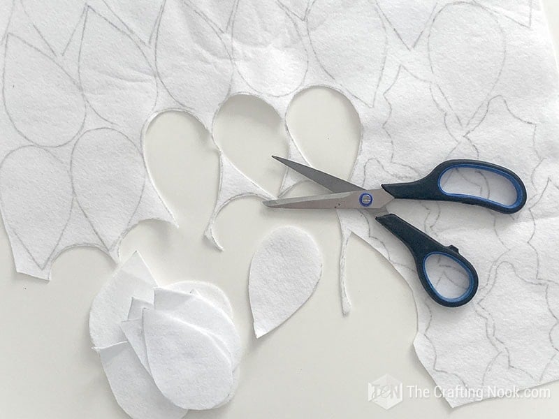 Cutting out the leaves shape from the white felt
