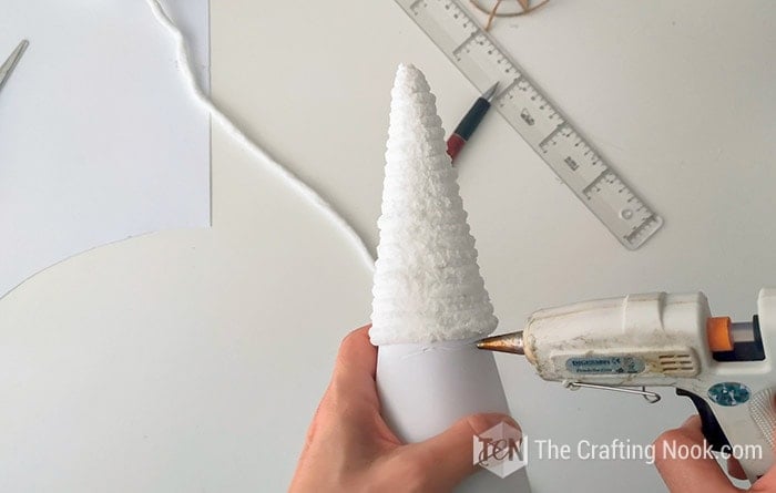 applying hot glue to the cone for further wrapping