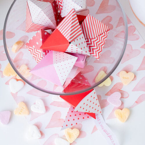 A closeup of the bunch of Origami fortune cookies in the dish