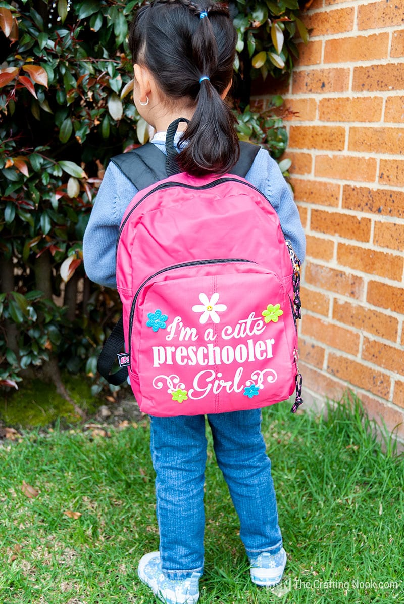 Backpack decoration with iron on viniyl on the girl's back