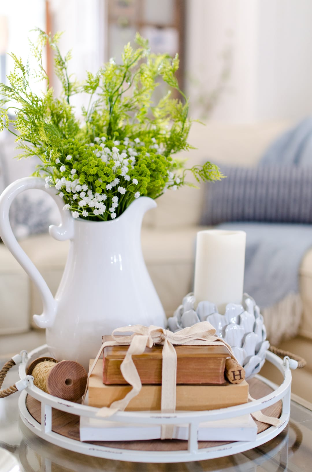 vignettes with a mix of old and new, vintage books and a flower jar