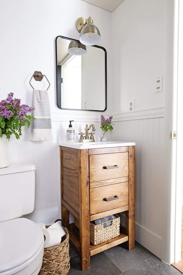 Decor Ideas For Small Bathrooms: rustic vanity with brass accessories; faucet, and towel rack.