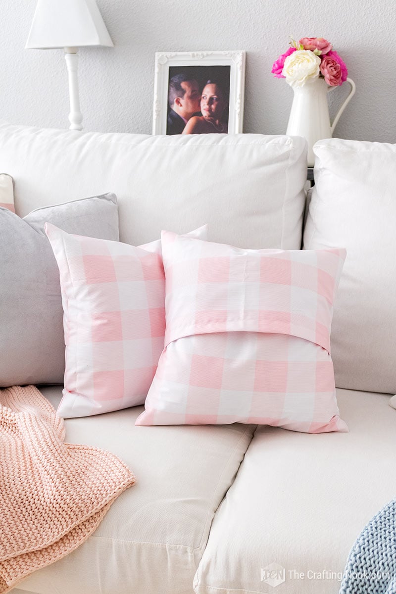 White and pink polka dot envelope pillows, one of the showing the back envelope opening.