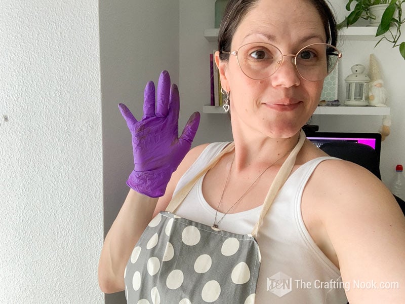 me wearing protective wear: apron and purple latex gloves.