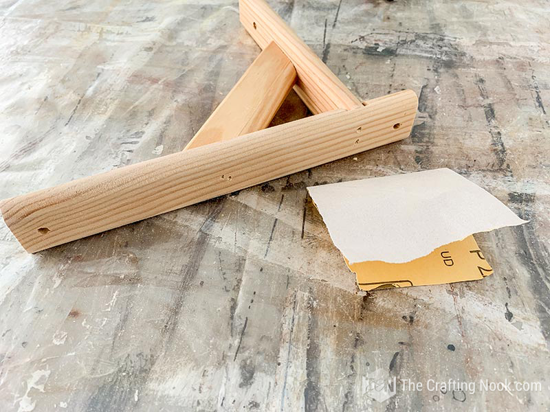 Sanding the shelf bracket.