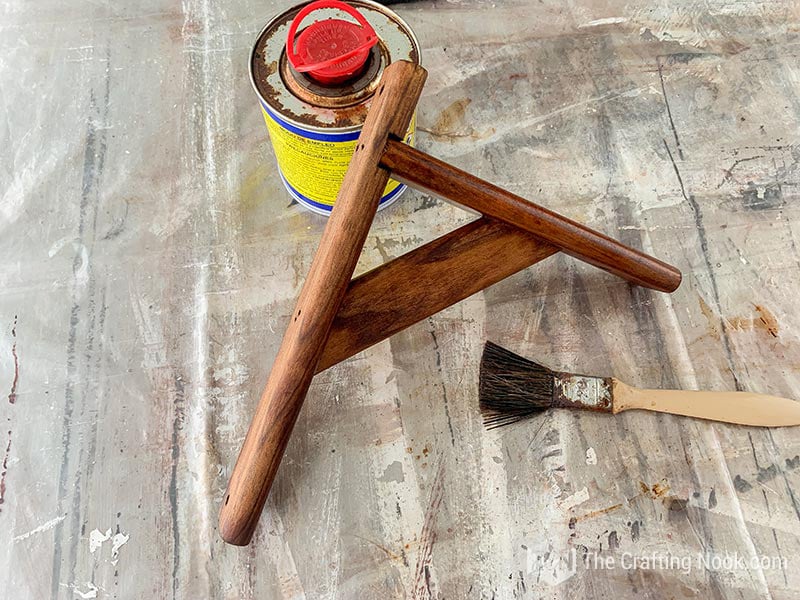 Staining the shelf bracket with walnut wood stain.