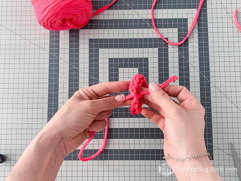 making a tight knot to close the bracelet