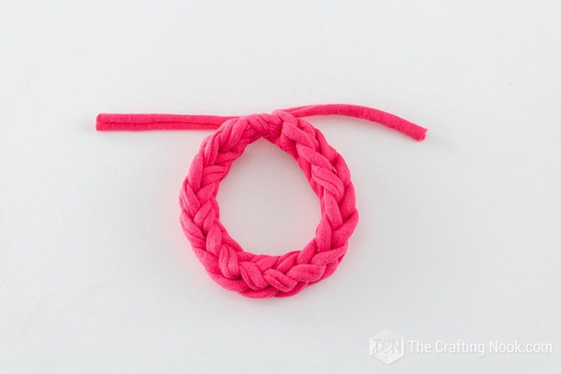 overhead view of the 2 fingers knitted bracelet color pink