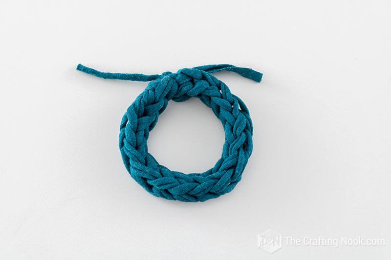 overhead view of the 2 fingers knitted bracelet color teal