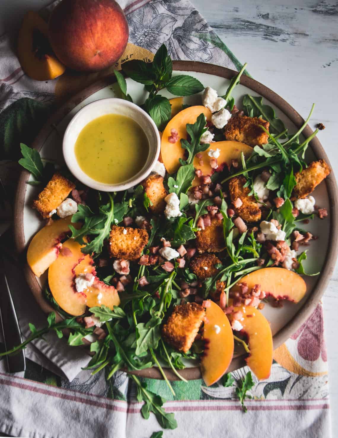 Arugula Salad with Peaches and Cornbread Croutons By Her Mise en Place
