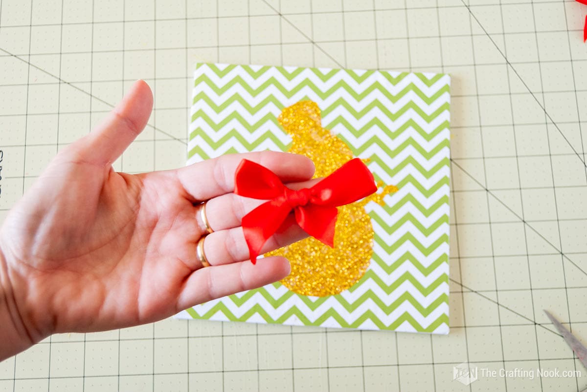  showing a red satin ribbon bows in my hand