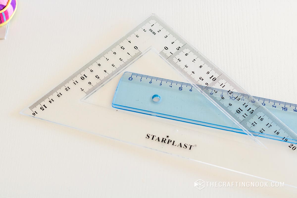 one blue ruler and a triangular squared ruler.