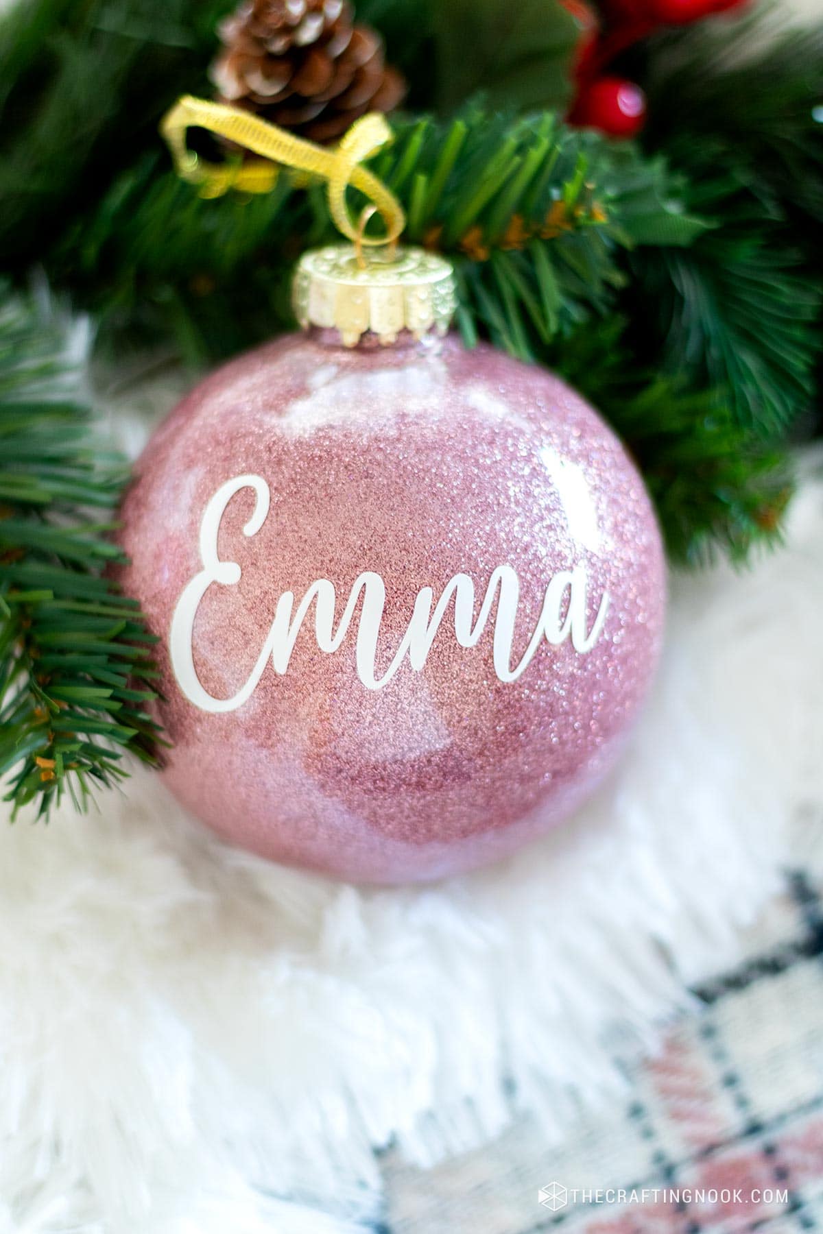 Personalized DIY Glitter Christmas Ornament on the table with faux fur and greenery