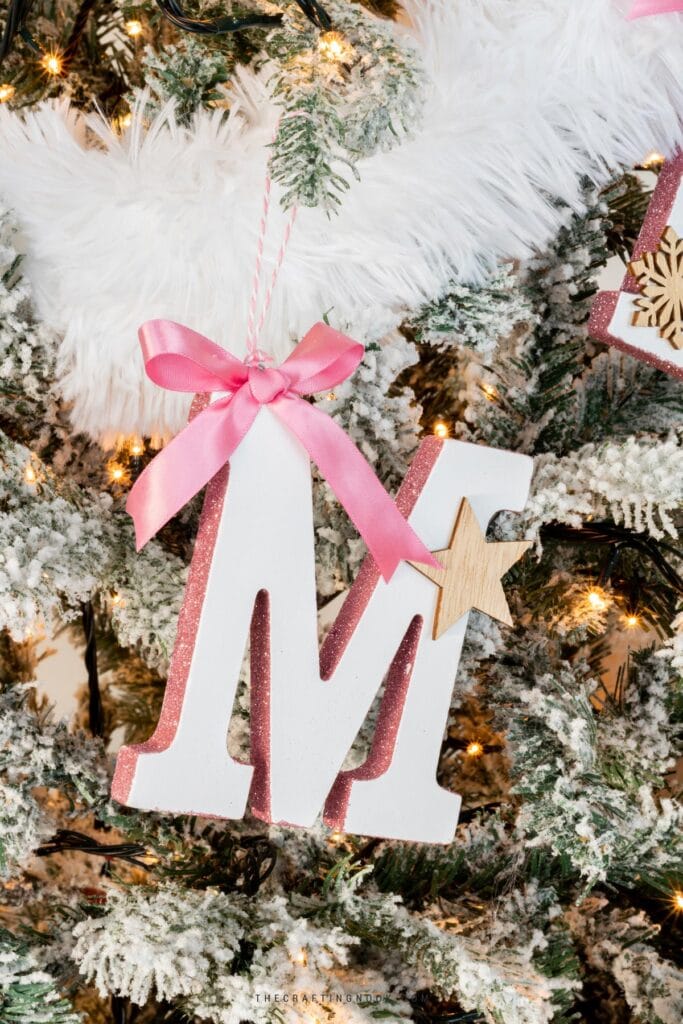 DIY Initial Letter Ornaments with Glitter on the side edges hanging on the tree letter M. Cover image