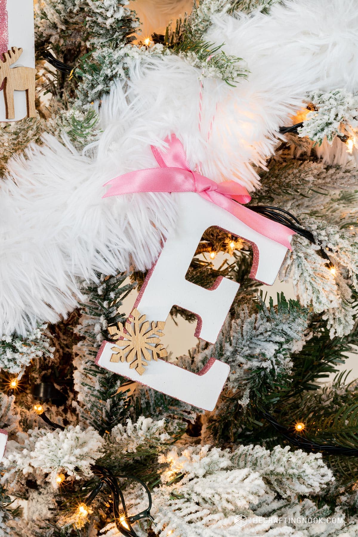 DIY Initial Letter Ornaments with Glitter on the side edges hanging on the tree letter E.