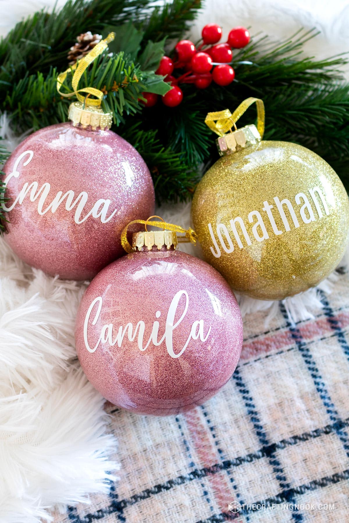 3 Personalized DIY Glitter Ornament on the table with faux fur and greenery