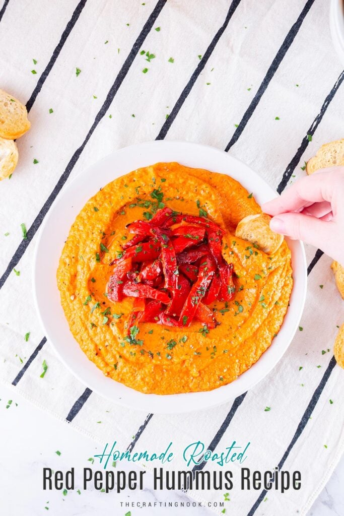 Homemade Roasted Red Pepper Hummus Recipe in a dish decorated with roasted pepper strips and me dipping a toast. Feature image with title text overlay