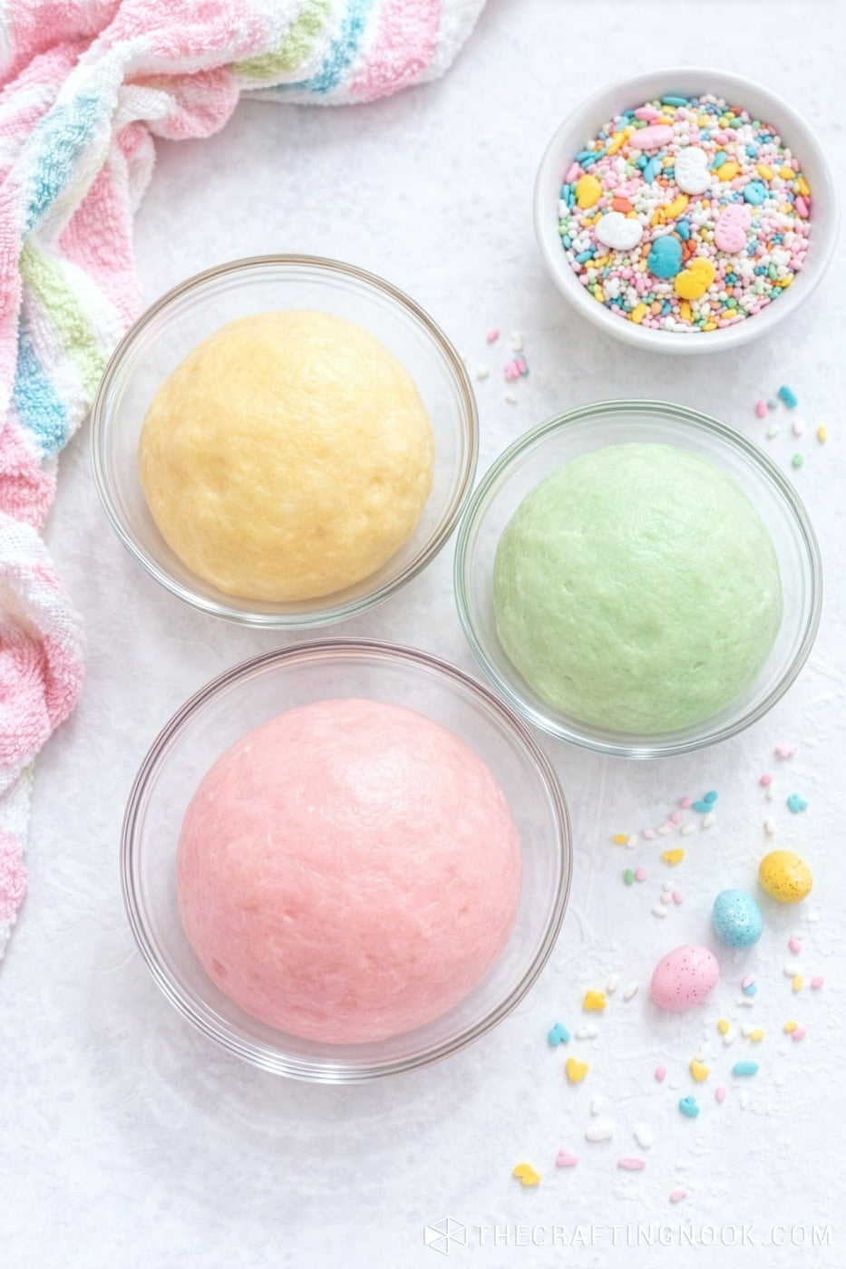 Colorful Easter condensed milk truffles dough with sprinkles in glass bowls.