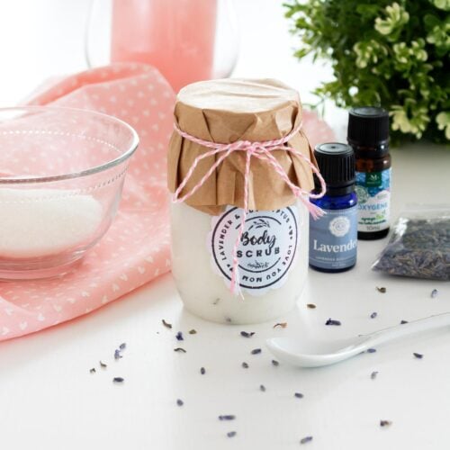 Eucalyptus Lavender Sugar Scrub Recipe beautifuly presented in a har with the lid decorated with craft paper and twine plus a cute label on the jar. Cover image.