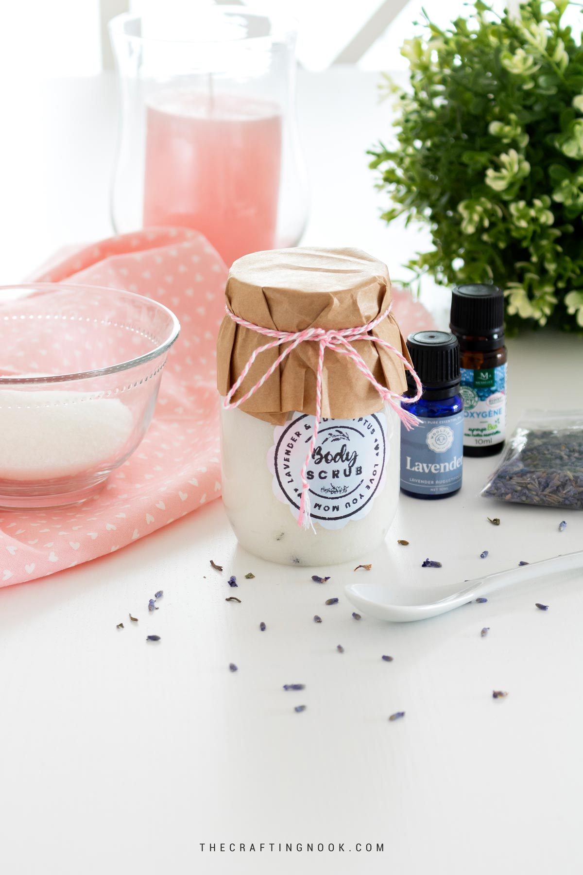 Eucalyptus Lavender Sugar Scrub Recipe beautifuly presented in a har with the lid decorated with craft paper and twine plus a cute label on the jar. Cover image.