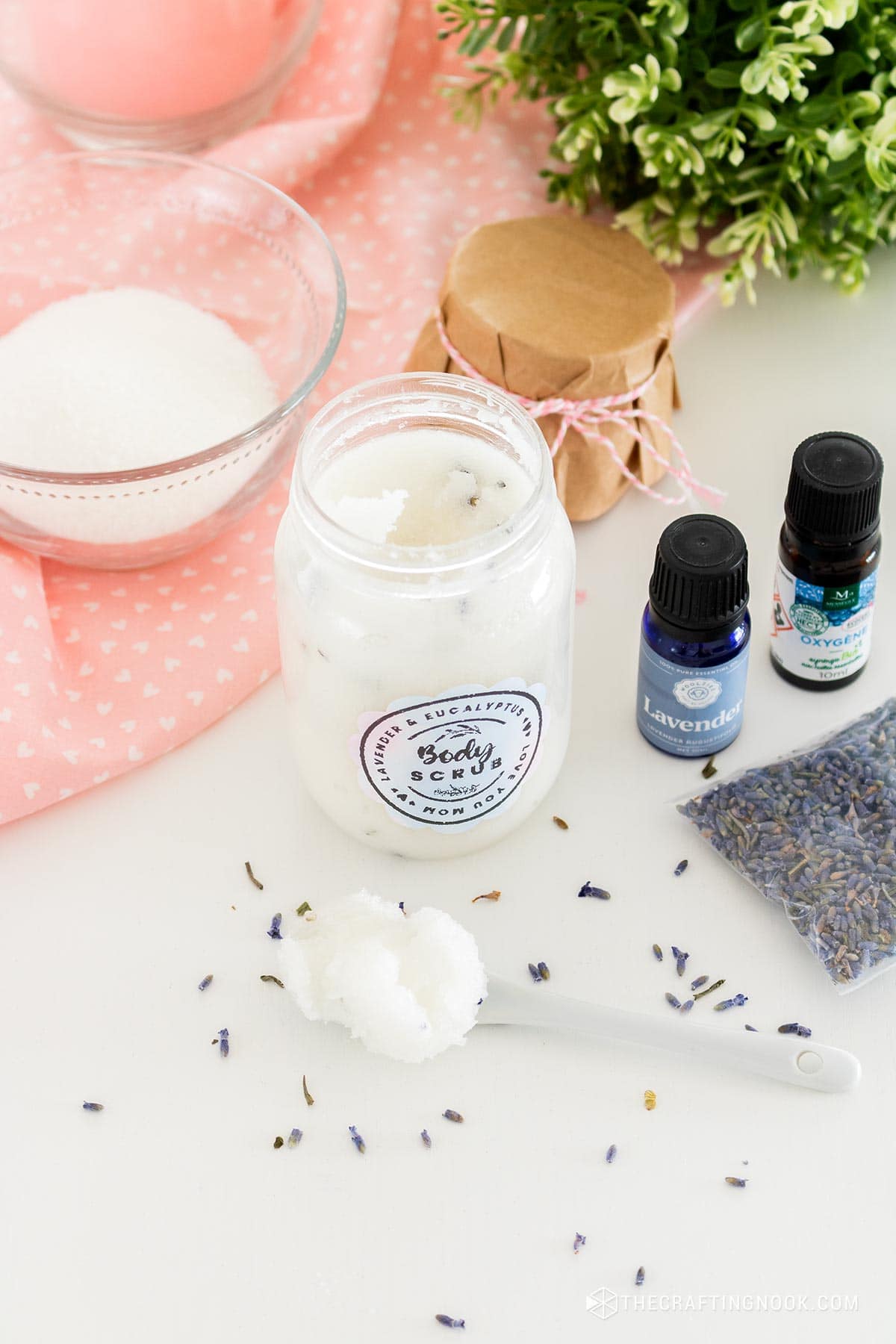 Eucalyptus Lavender Sugar Scrub Recipe in the jar and also scooped in a cute spoon on the table