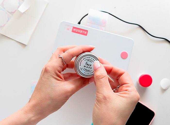 placing the label on the lid of the lip balm jar