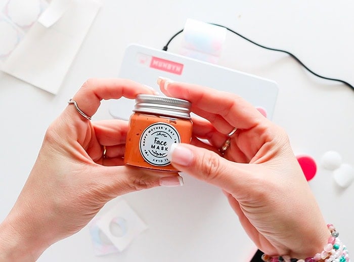 placing the label on the side of the lip balm jar