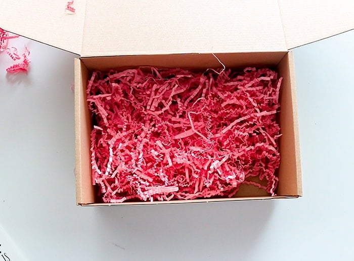 showing a layer of shredded paper inside the box