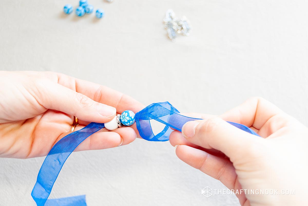 Tying a simple knot before and after each group of beads
