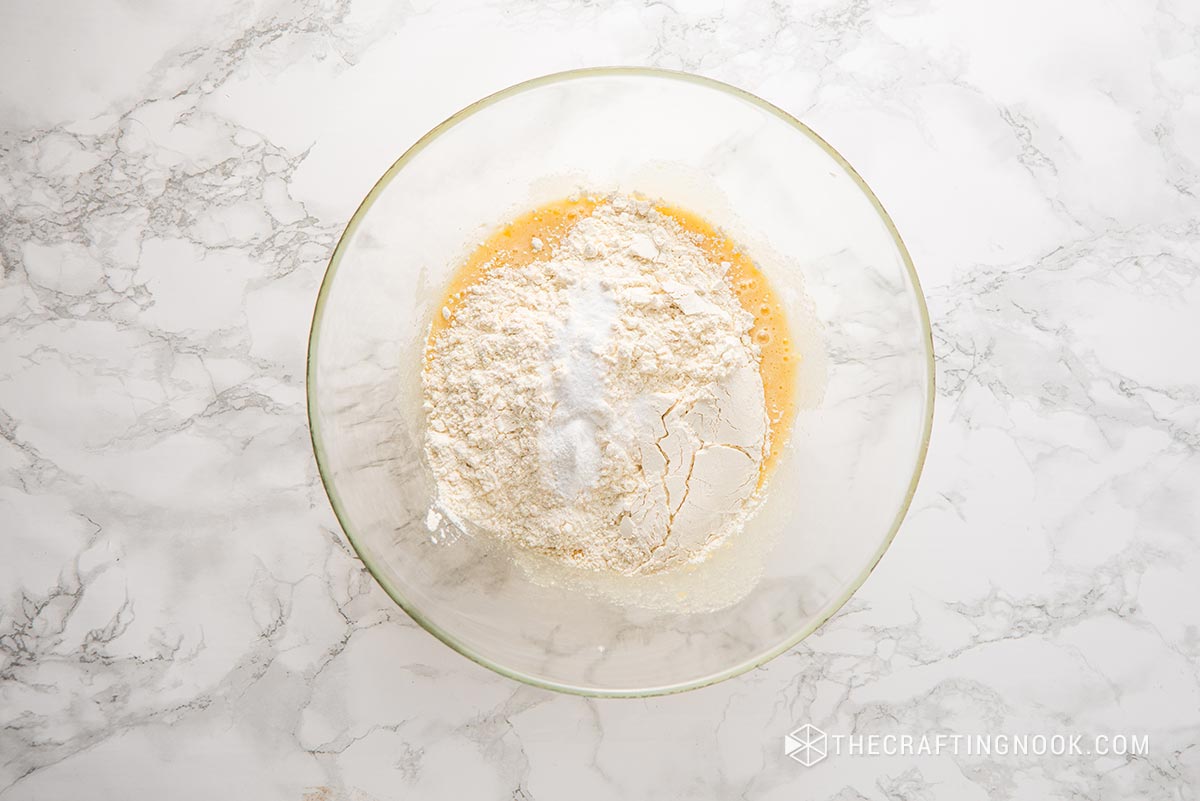 top view of add the flour, baking powder, baking soda, pinch of salt and mixture in a bowl