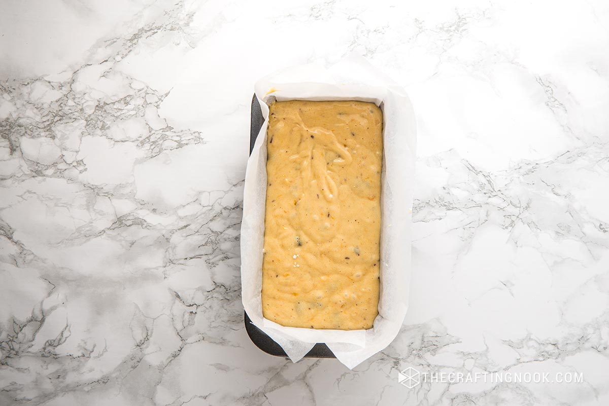 top view of the entire mixture poured into the rectangular baking mold with baking paper
