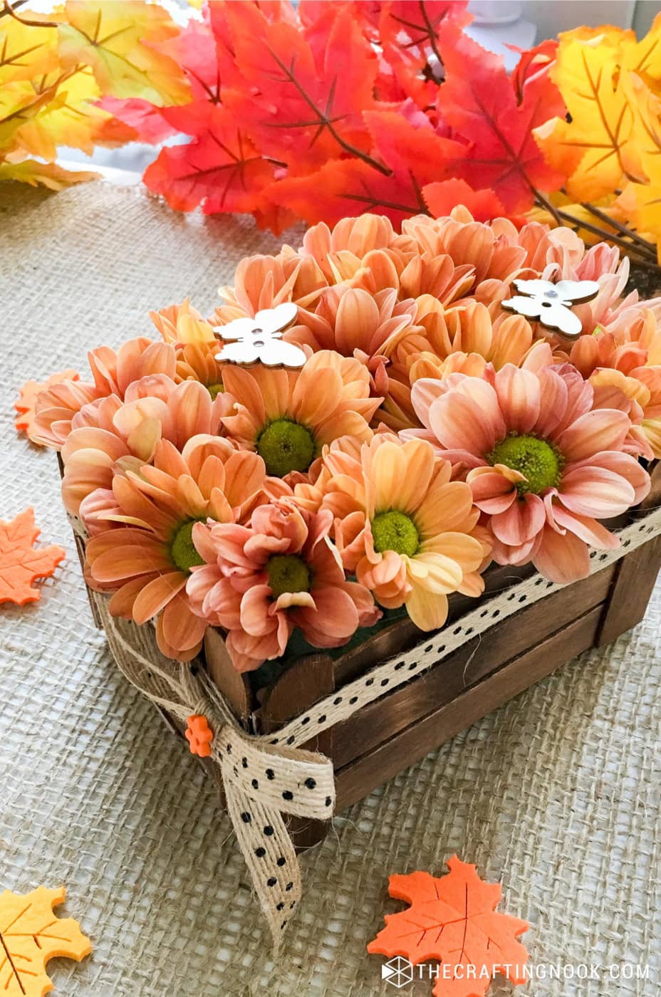 Slight overhead view of the DIY Thanksgiving flower centerpiece with Popsicle Sticks Crate decorated with cute ribbons