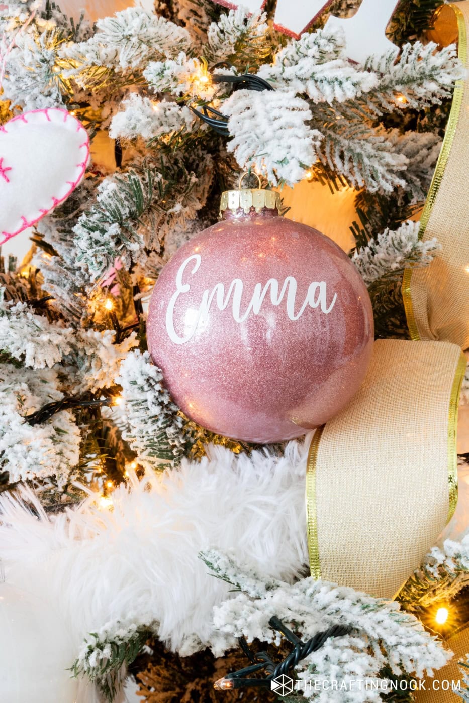 A Pink Glitter Ornament with Emma Name on it