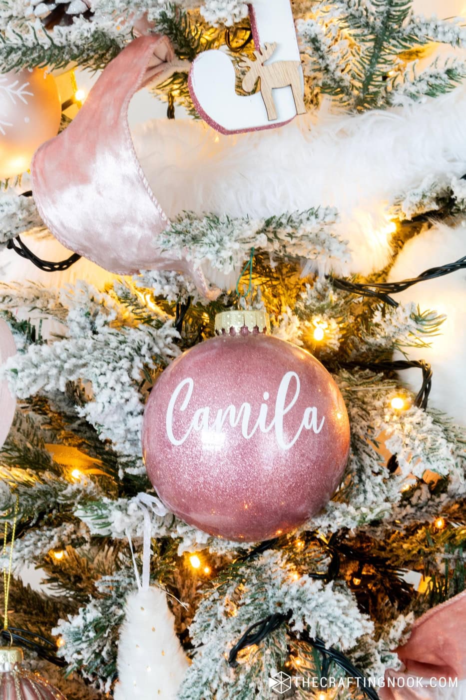 A Pink Glitter Ornament with Camila Name on it