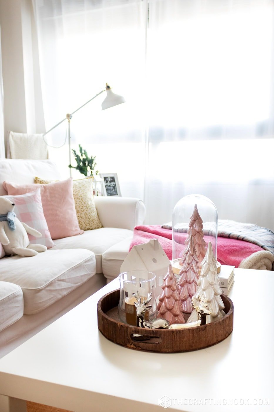 close view of centerpiece on coffee table with ceramic pine cones in pink and white
