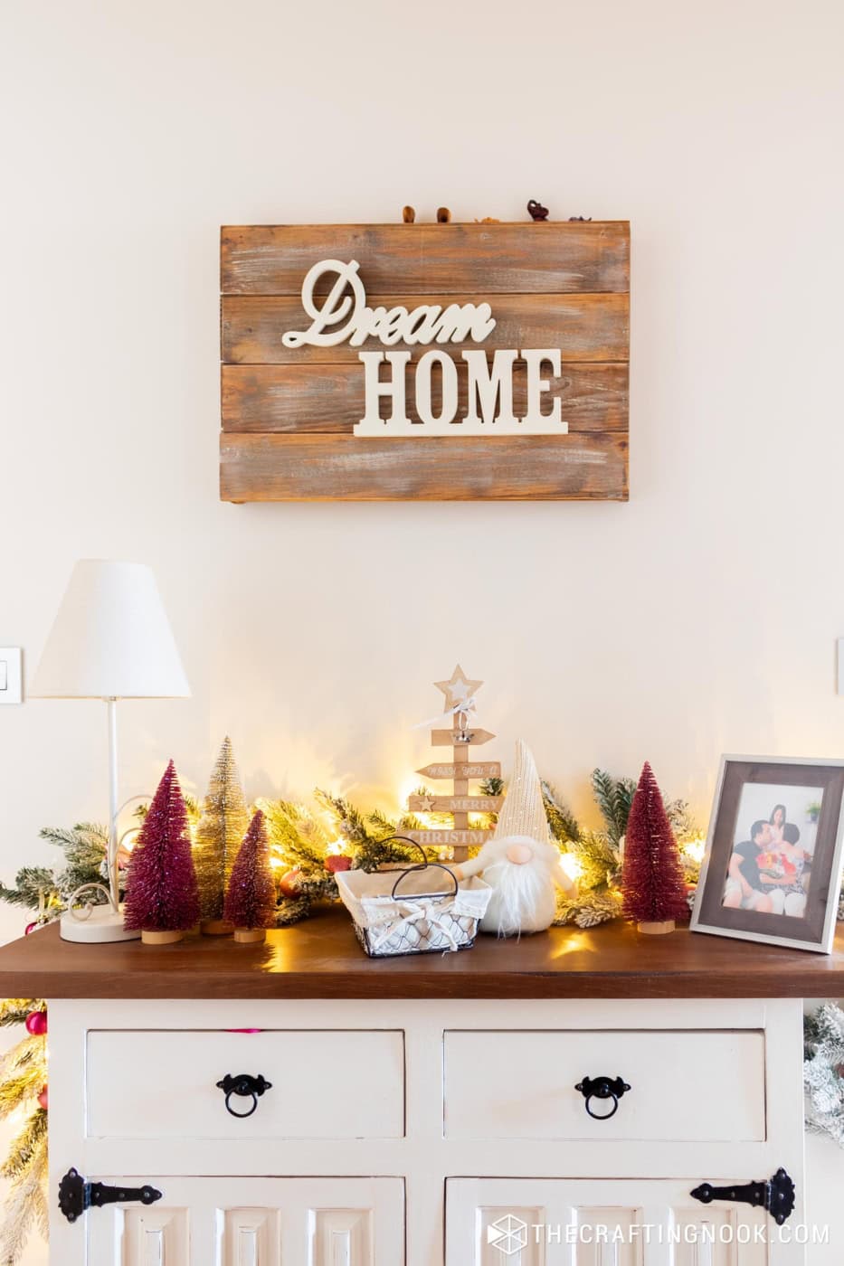 front view of the console table with Christmas decoration and lights to give a warm tone