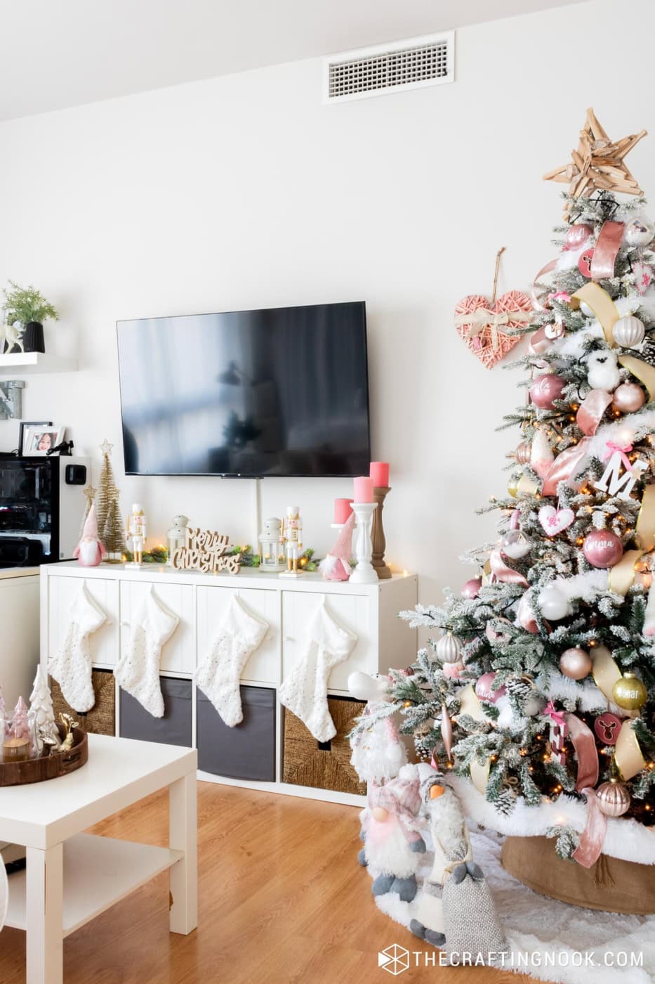 general view of the television space and the furniture below decorated with Christmas elements and part of the tree on the right side of the image