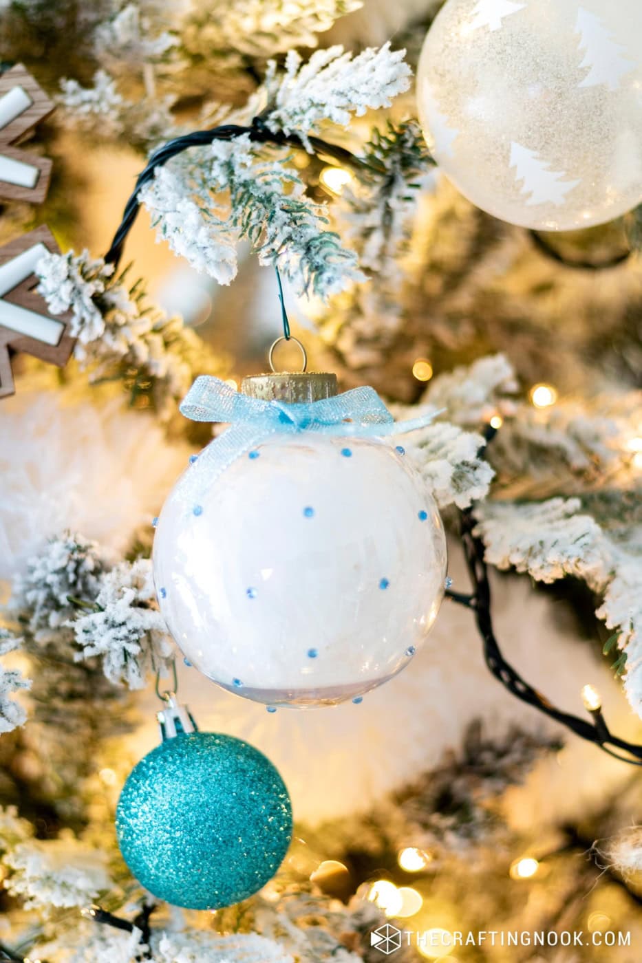 Cute Rhinestone Christmas Ornaments filled with feathers hanging on the tree