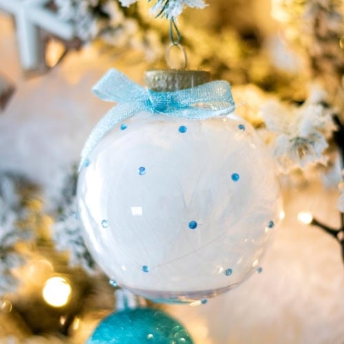 DIY Rhinestone Christmas Ornaments Filled with Feathers hanging on the tree. Cover Image