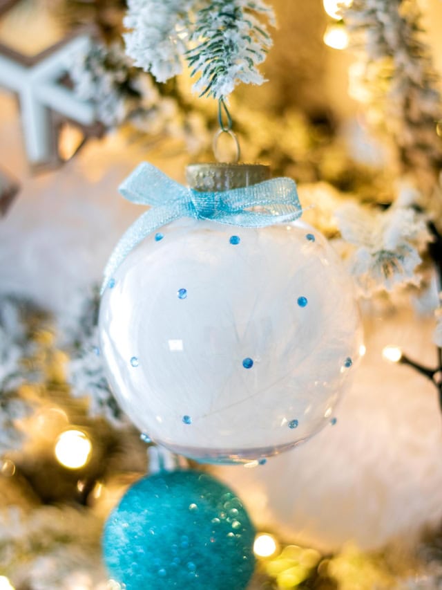 DIY Rhinestone Christmas Ornaments Filled with Feathers hanging on the tree. Cover Image