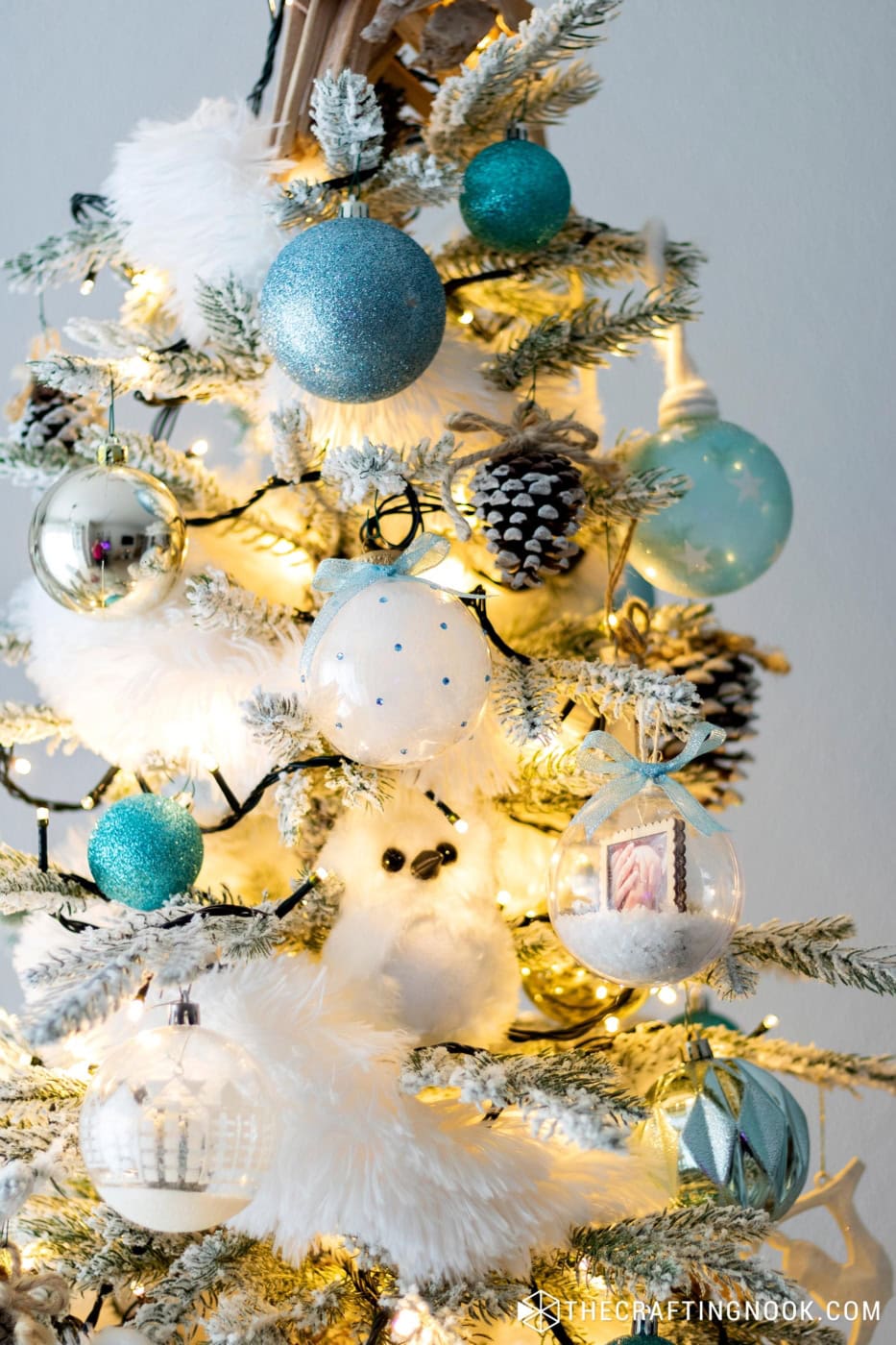 Cute Rhinestone Christmas Ornaments filled with feathers hanging on the tree